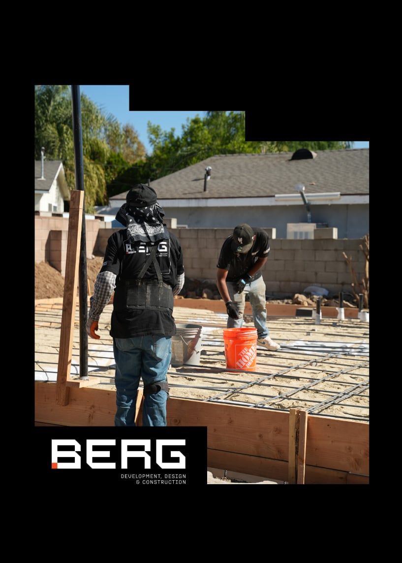 Two workers at a construction site with BERG logo and rebar foundation in progress.
