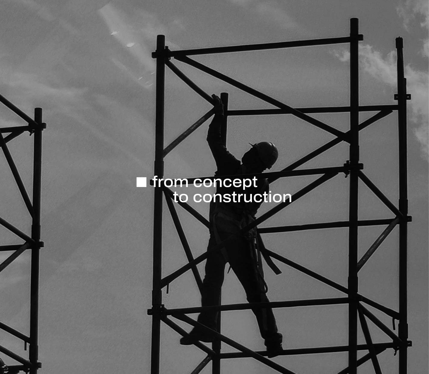 Black-and-white photo of a construction worker silhouetted against the sky, standing on scaffolding. White text overlaid reads “from concept to construction.”